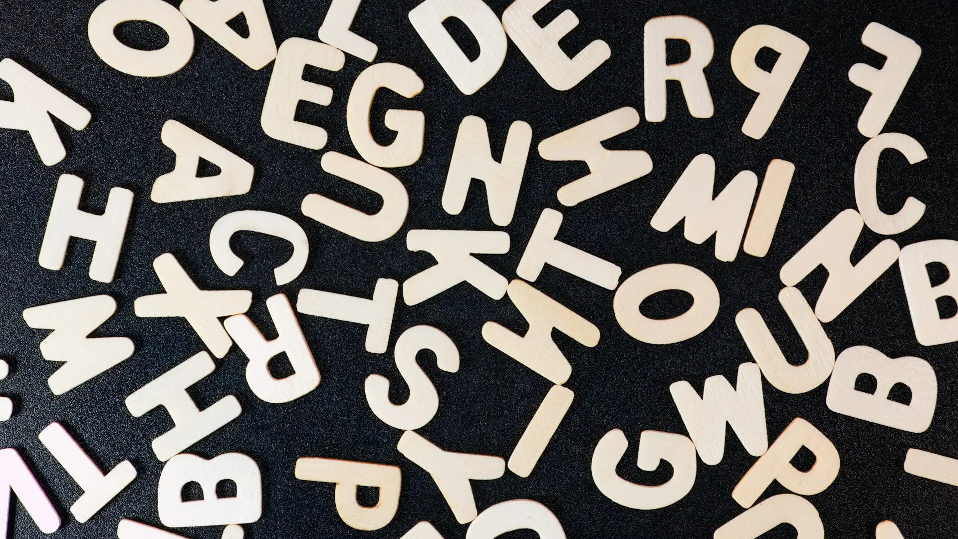 a close up of a black surface with white letters